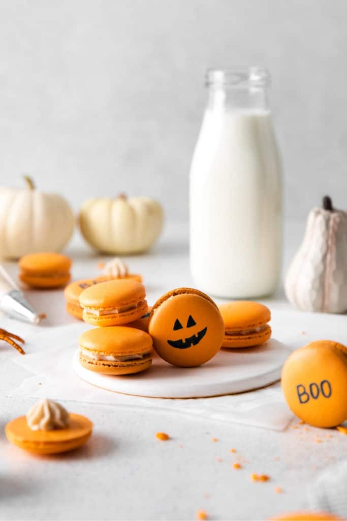 Halloween pumpkin macarons with Jack 'o Lantern faces.