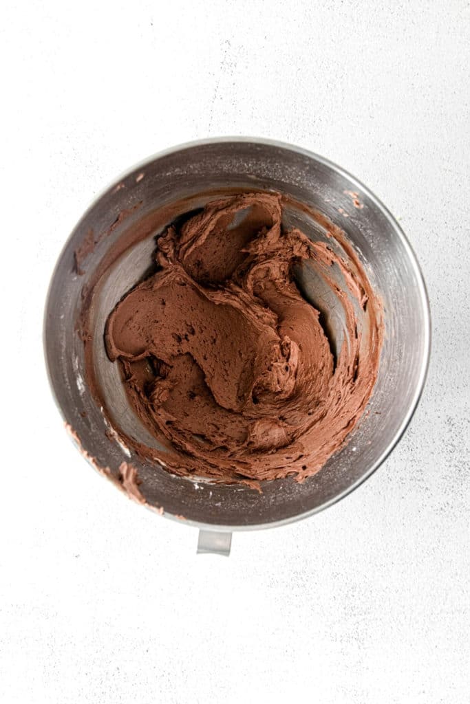 Chocolate Buttercream Frosting in a stainless steel mixing bowl.