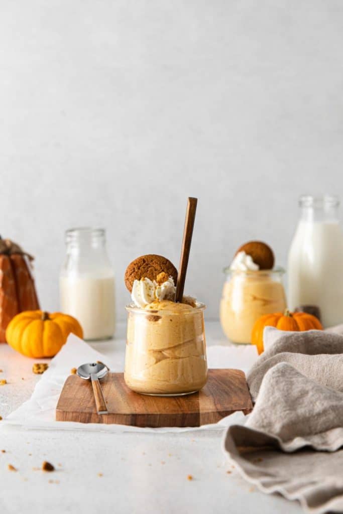 Pumpkin Cheesecake Mousse served in small glass jars with spoons.