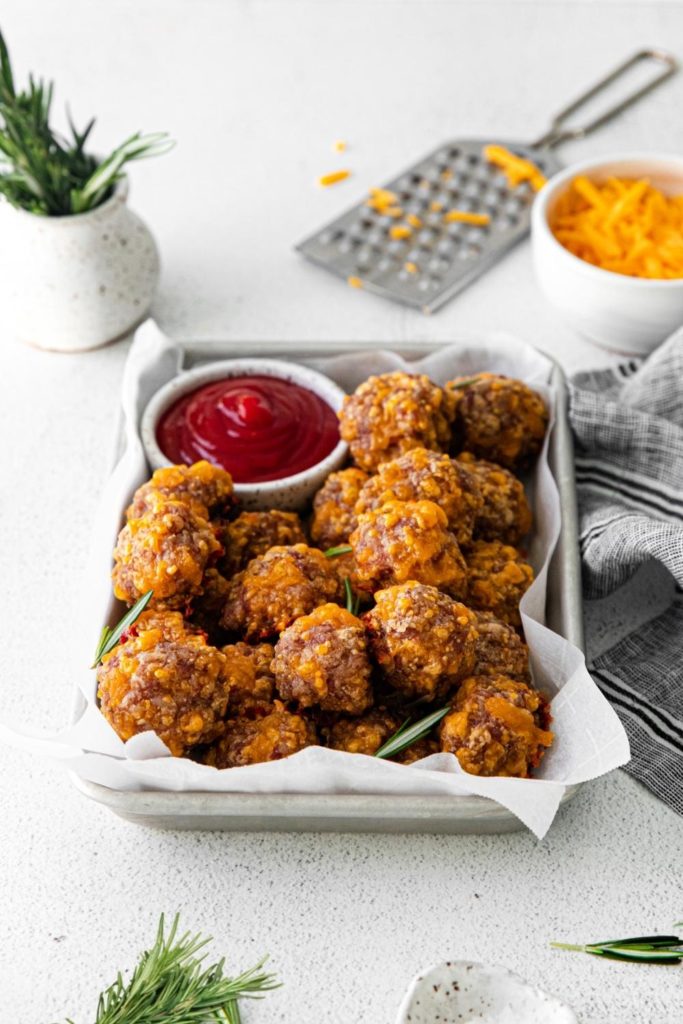 Bisquick sausage cheese balls served fresh from the oven on a metal tray.