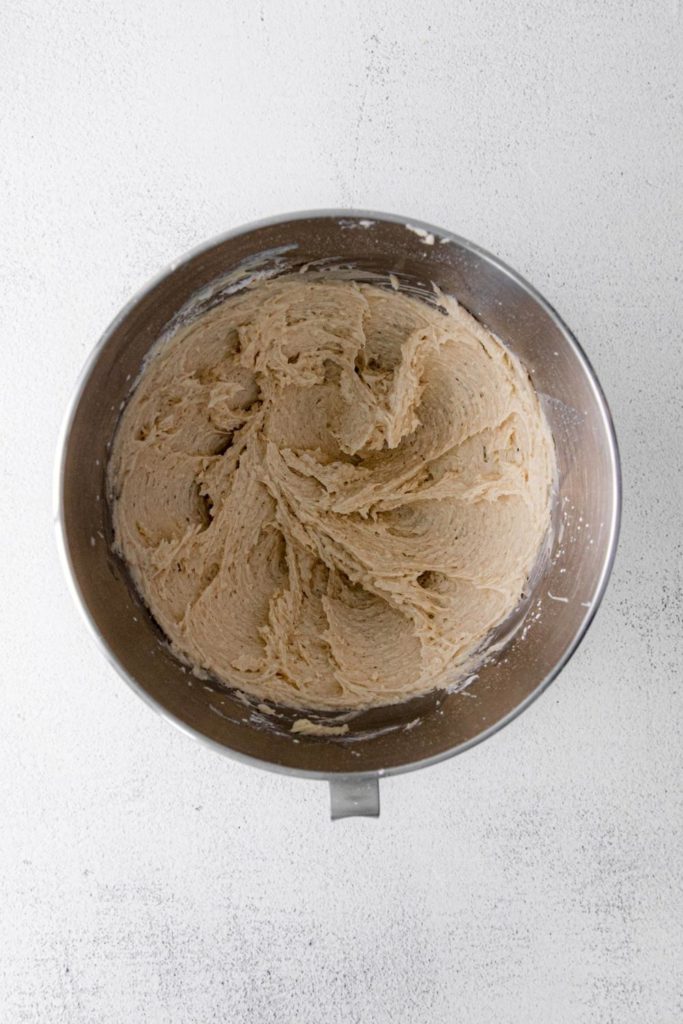Spiced white chocolate buttercream frosting in a metal mixing bowl.