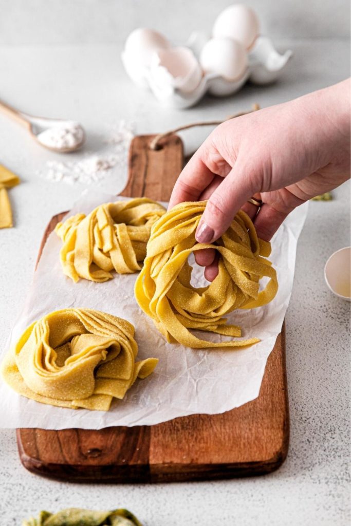 Assembling pasta nests from fresh homemade pasta.