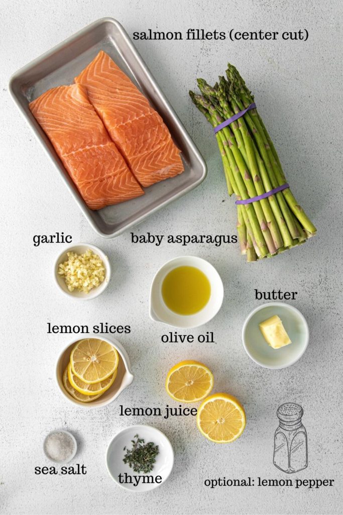 Ingredients for lemon garlic-butter salmon sheet pan dinner with baby asparagus.