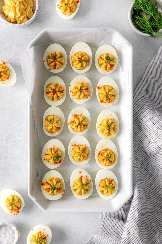 Angel Deviled Eggs arranged in a white rectangular serving dish.