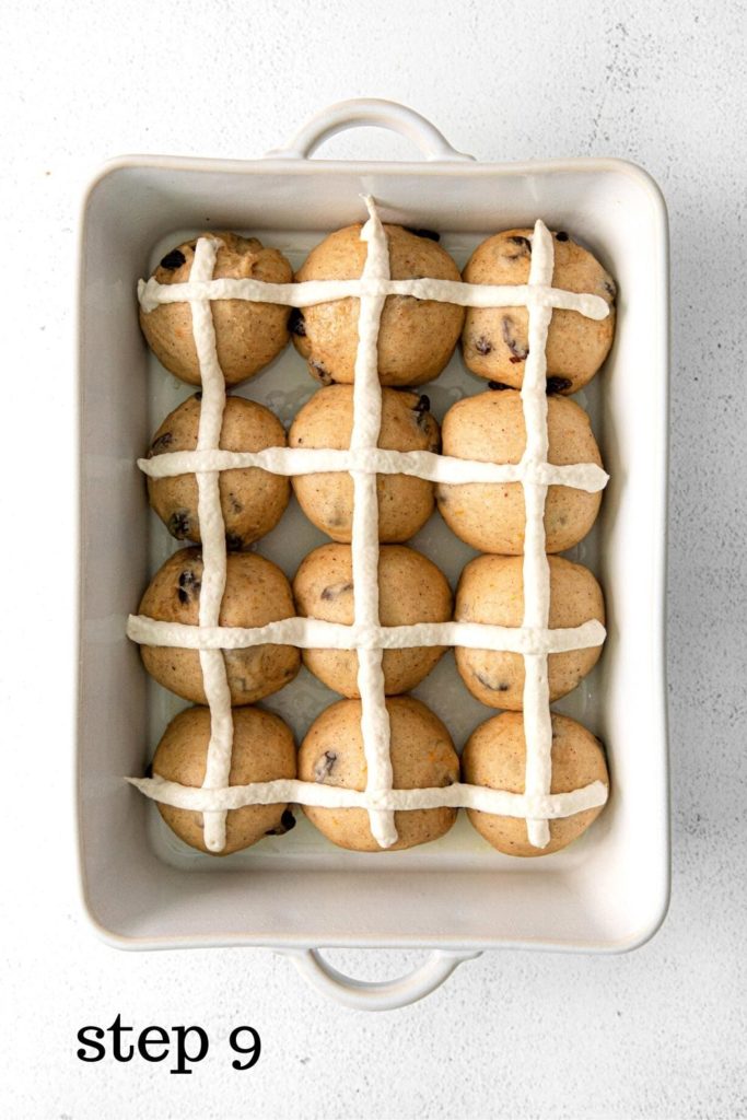 Piped-on flour mixture in the shape of crosses on hot cross buns before baking.