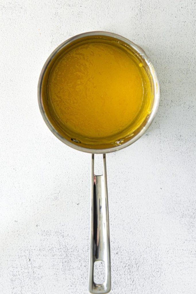 Small saucepan with freshly-made lemon curd.