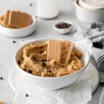 Cookie dough hummus made with chickpeas served in a dip bowl with graham crackers.