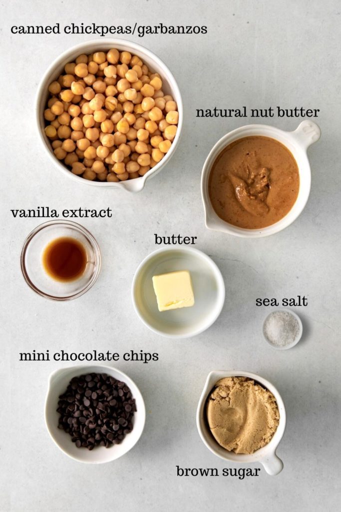 Ingredients for chickpea cookie dough hummus dessert dip with chocolate chips.