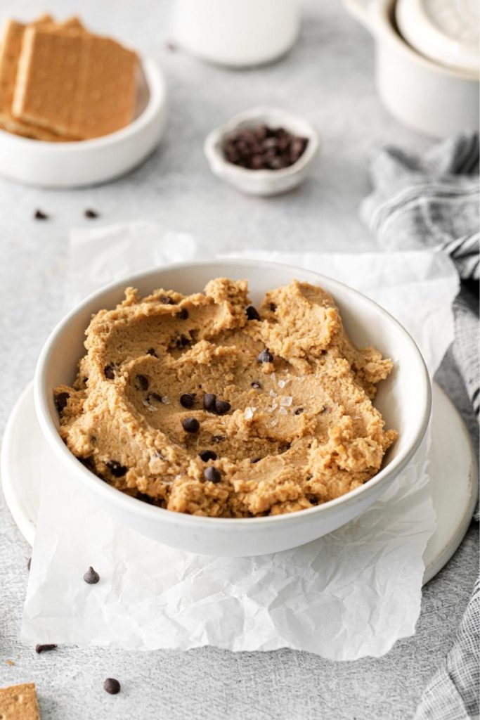 Chickpea cookie dough hummus garnished with mini chocolate chips and flaky sea salt.