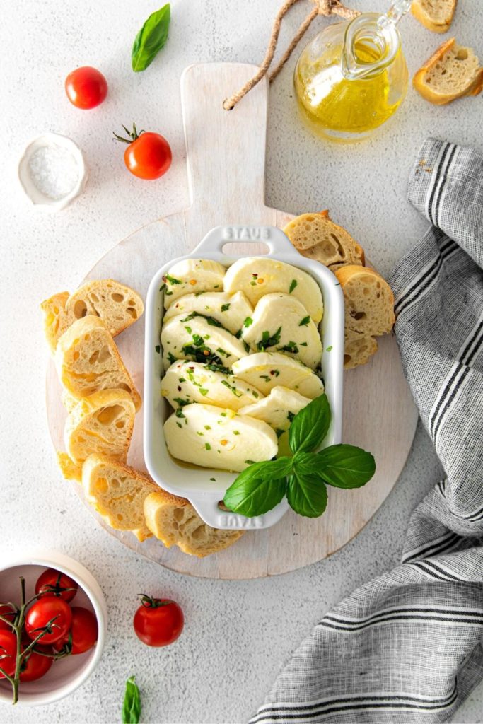 Marinated mozzarella served with slices of rustic baguette.