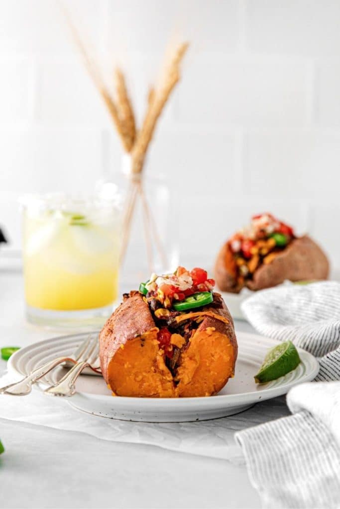 End sliced off a stuffed sweet potato to expose the vegetable's flesh and taco filling.