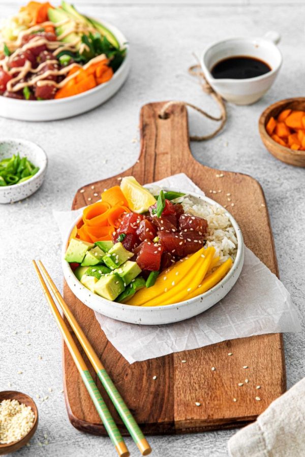 Spicy Ahi Tuna Poke Bowl on a serving table with chopsticks.