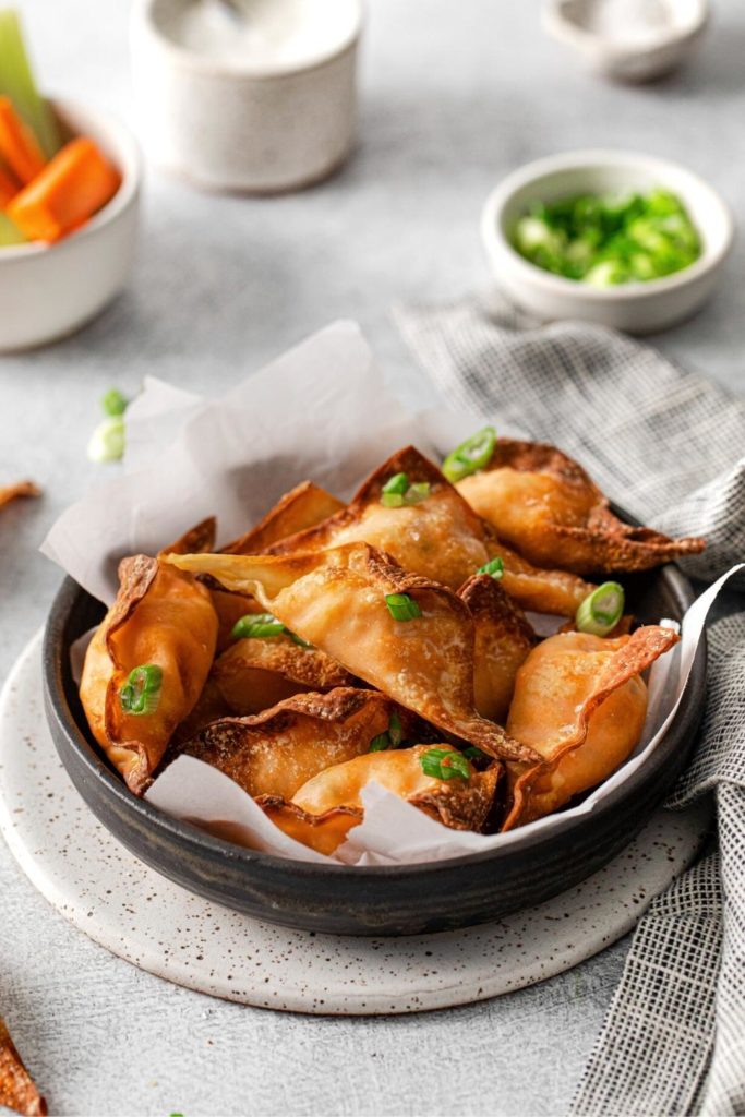 Air fryer wontons garnished with green onions.