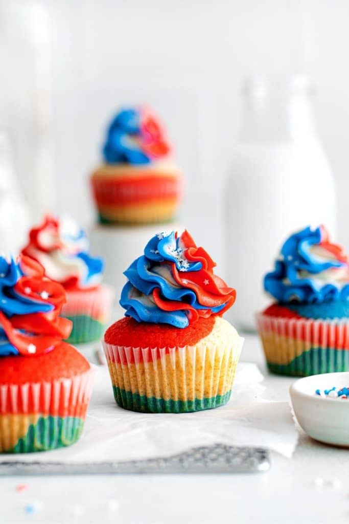 Five fourth of July cupcakes with swirled red, white & blue frosting.