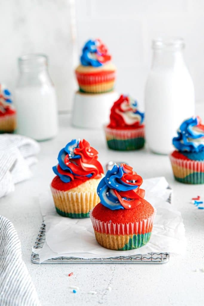 American Flag Cupcakes topped with swirls of tri-colored buttercream frosting in red, white & blue.