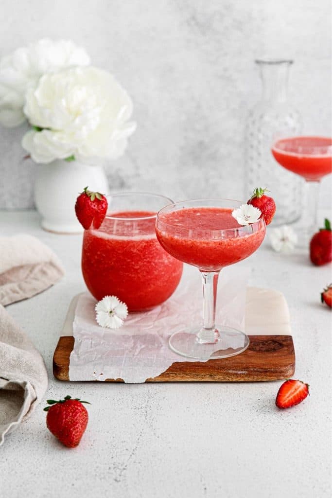 Three frozen cocktails made with frozen strawberries, rose wine and honey.