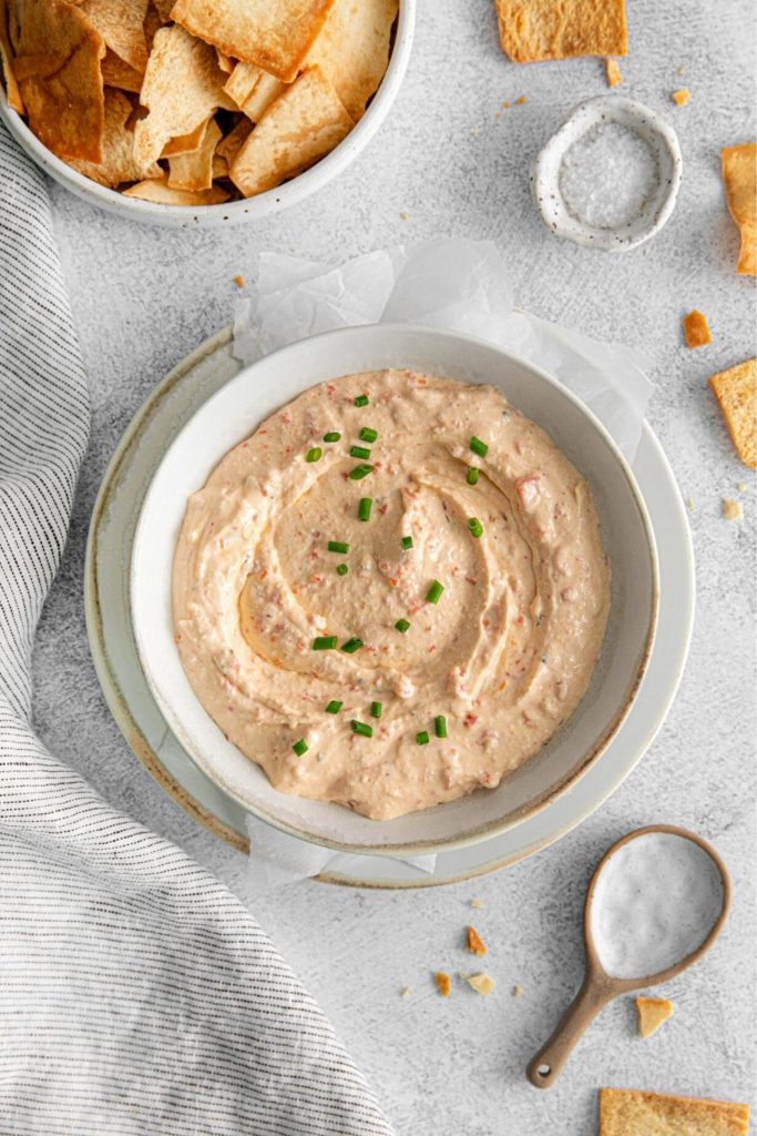 Whipped feta dip recipe assembled in a small bowl and garnished with green onions.