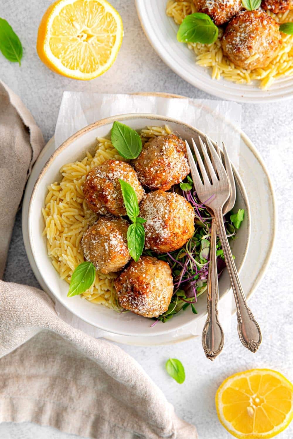 Lemon butter chicken meatballs served on orzo and drizzled with lemon brown butter sauce.