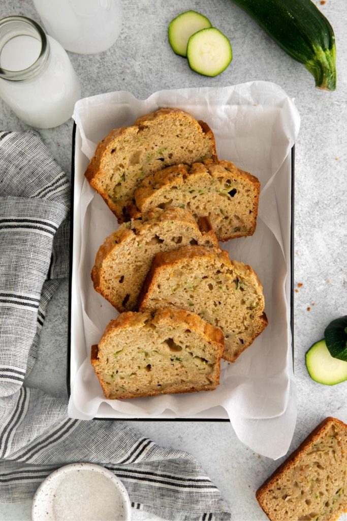 Slices of Mom's Zucchini Bread arranged in a white serving tray.