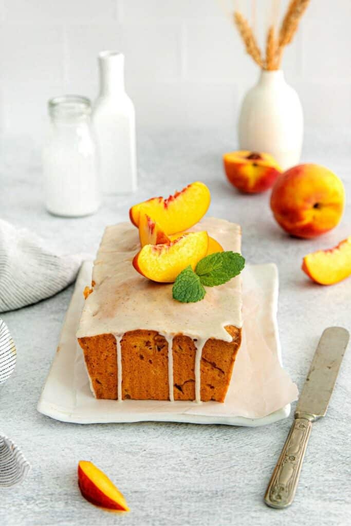 Georgia peach pound cake loaf on a platter with end sliced off so tender texture is visible.