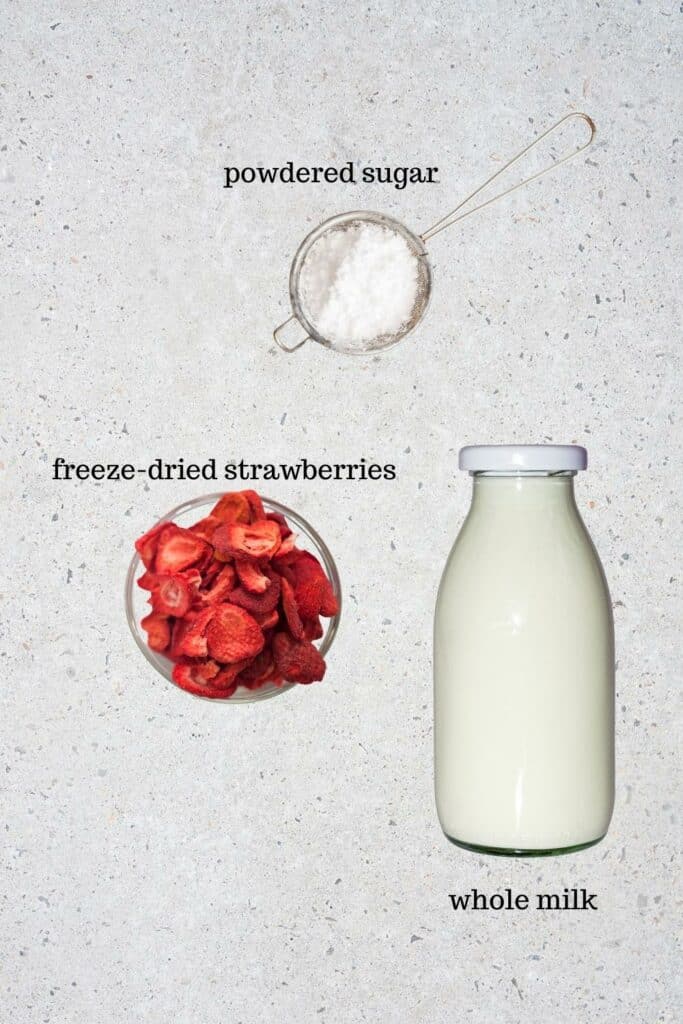 Ingredients for pink strawberry donut glaze: powdered sugar, whole milk, freeze-dried strawberries.