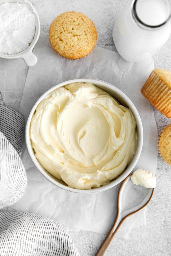 Thick, luscious vanilla buttercream frosting in a bowl with spoon.