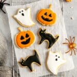 Iced Halloween sugar cookies in the shape of Jack-o'-lanterns, ghosts and black cats.