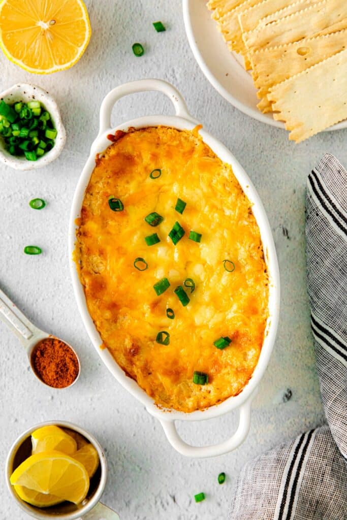 Cheesy Cajun crab dip pulled hot from the oven and garnished with sliced green onions.