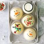 Christmas hot chocolate bombs in 3 designs: snowman, string of Christmas lights, and truffles.
