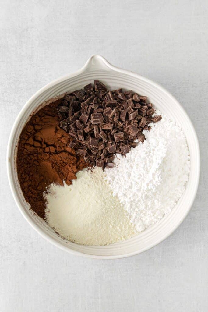 Ingredients for homemade hot chocolate 
mix in a medium bowl, waiting to be combined.