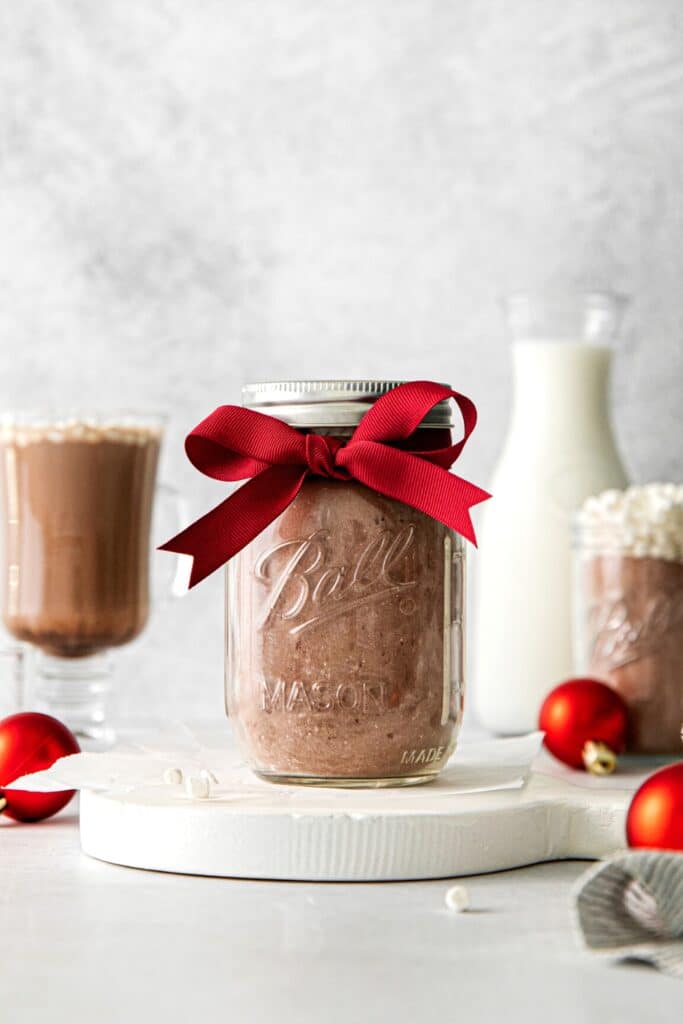 Homemade hot chocolate mix in a mason jar tied with a red ribbon.