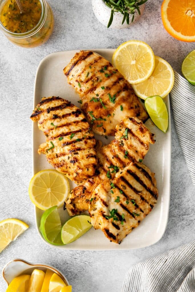 Grilled chicken on a platter prepared with a Mexican citrus marinade.