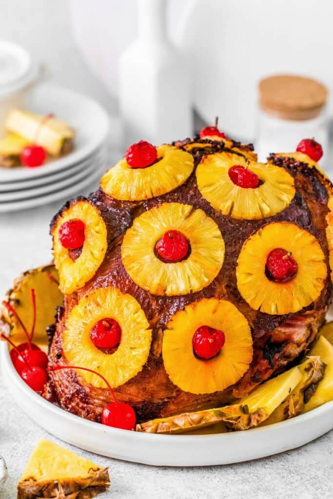 Brown sugar glazed ham with pineapple rings and maraschino cherries.