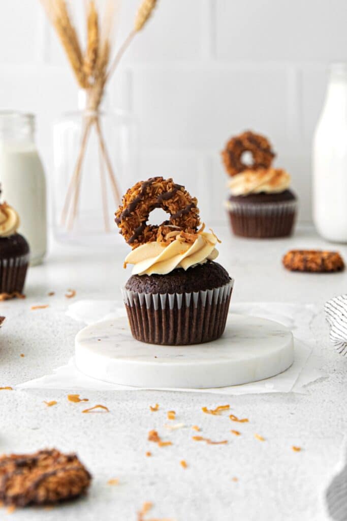 German chocolate cupcakes topped with caramel buttercream, toasted coconut and Samoas Girl Scout cookies.