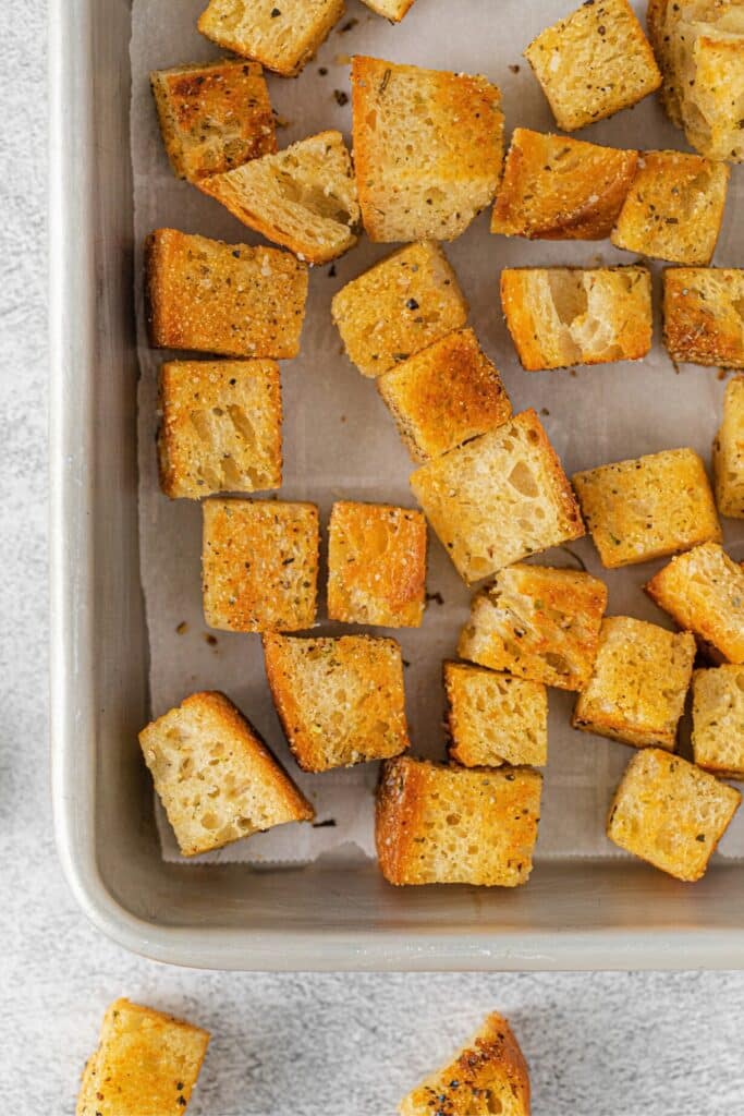 Crispy homemade croutons on a baking tray.