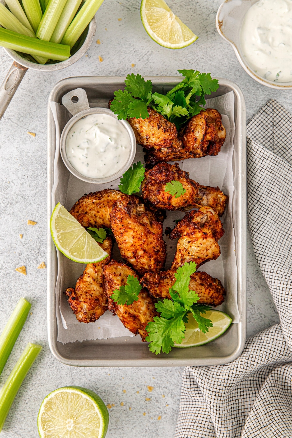 Tequila lime wings on a serving tray with creamy tequila-lime dipping sauce.
