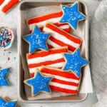 4th of July cookies in the shape of stars and stripes, decorated in red, white and blue.