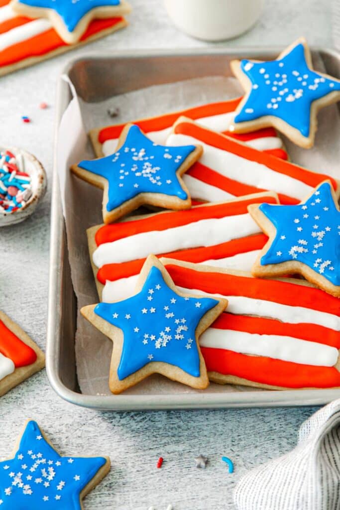 Shortbread fourth of July cookies in flag and star shapes decorated in red, white and blue.