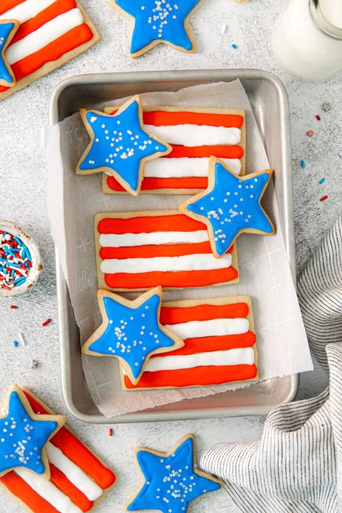 Stars and stripes 4th of July cookies on a small metal tray.