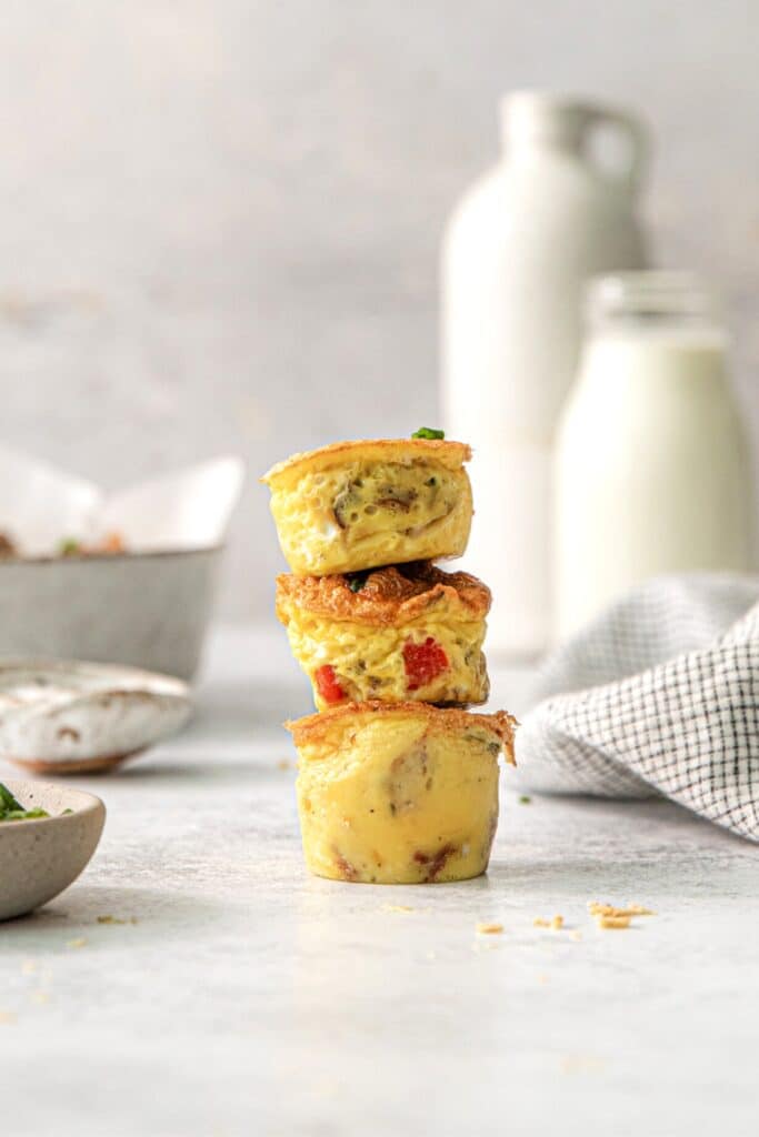 A stack of 3 egg bites to show their tender fluffy texture and tasty add-ins.