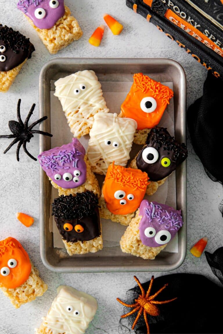 Halloween monster and mummy Rice Krispie Treats on a serving tray.