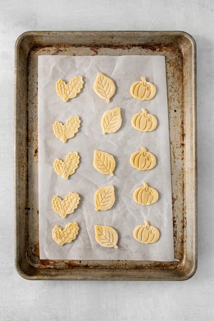 Fall pie crust cookies on a lined baking tray.