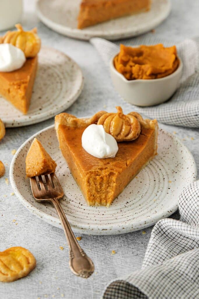A slice of Libby's Pumpkin Pie on a dessert plate with fork.