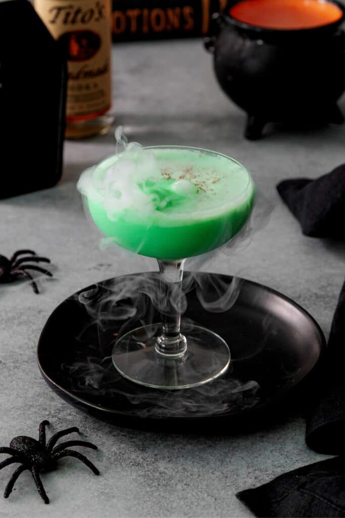 A Halloween Martini with wisps of fog lifting out of the glass from a little piece of dry ice.