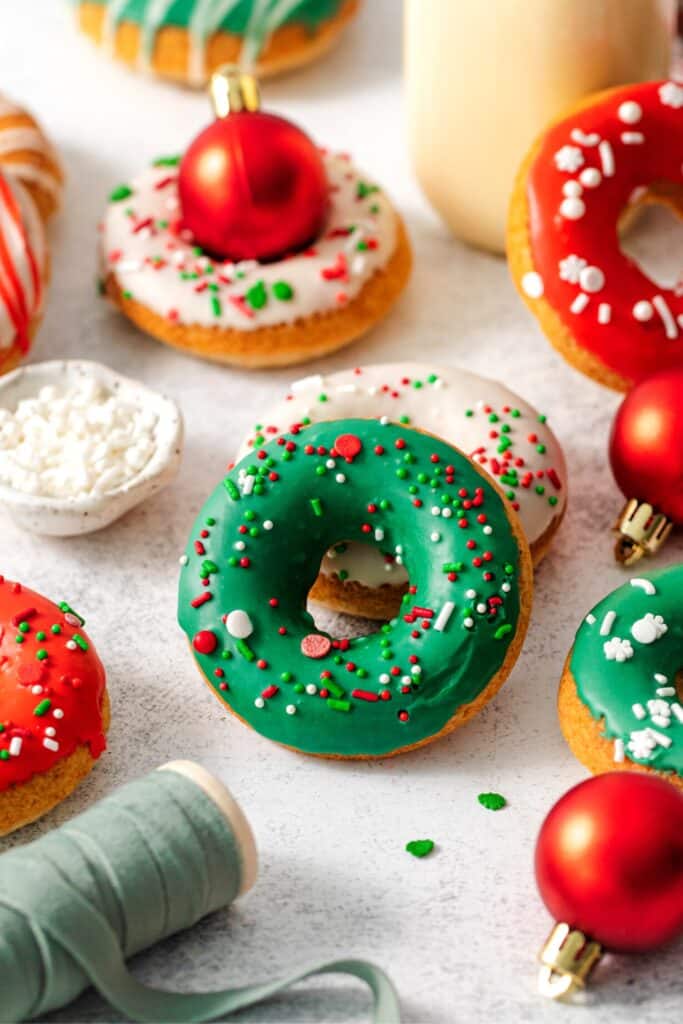 A batch of Christmas donuts on a dessert table.
