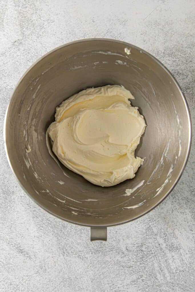 Whipped butter in the metal bowl of a stand mixer.