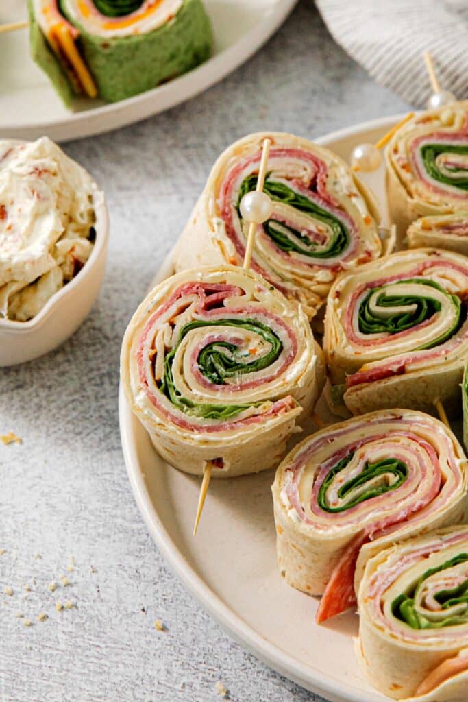Pinwheel sandwiches served on an appetizer tray with party picks.