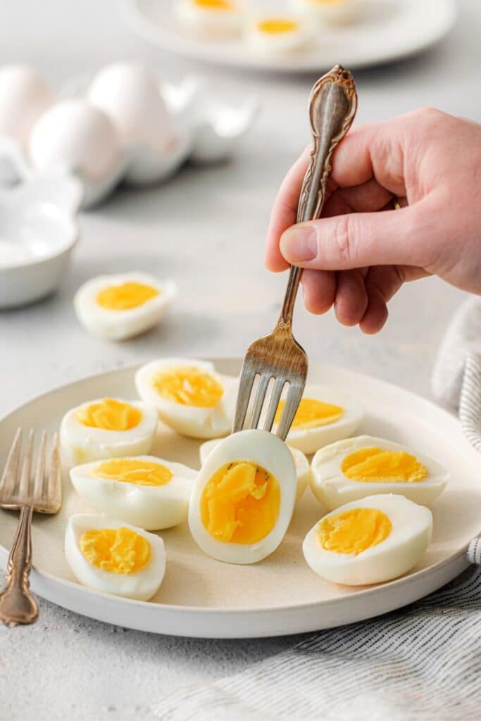 Serving air fryer soft boiled eggs with a fork.