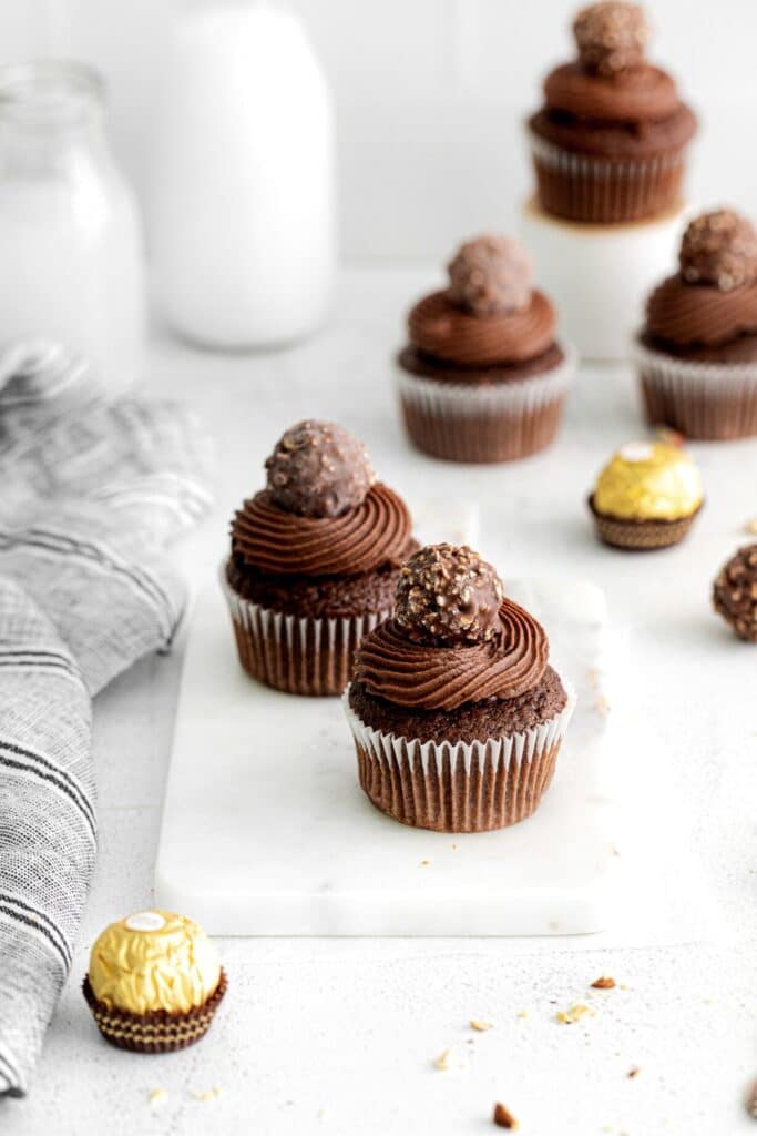Ferrero Rocher cupcakes on a serving table.