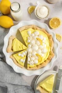 No-bake lemon pie cleanly sliced in a pie dish.
